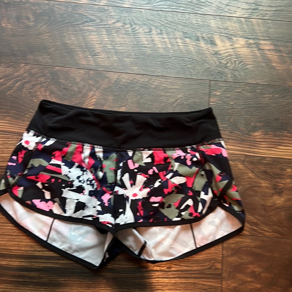 Lululemon size 4 running shorts with navy/black/olive/white/pink/melon pattern.